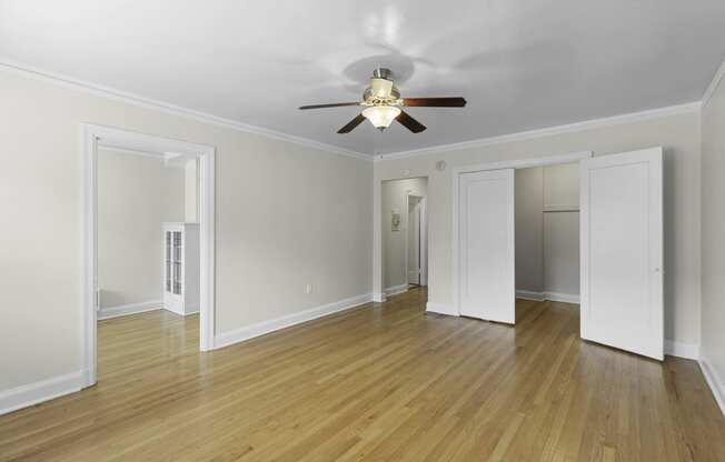 a spacious living area with plank floors and a ceiling fan at Charbern Apartment Homes, Seattle, 98122