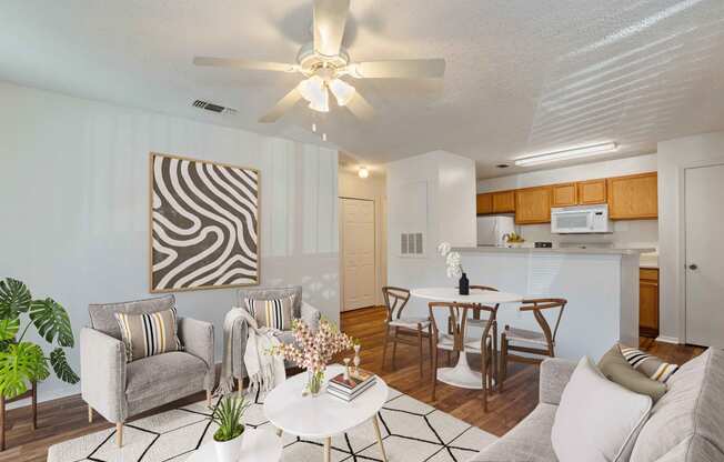 a living room and kitchen with a ceiling fan