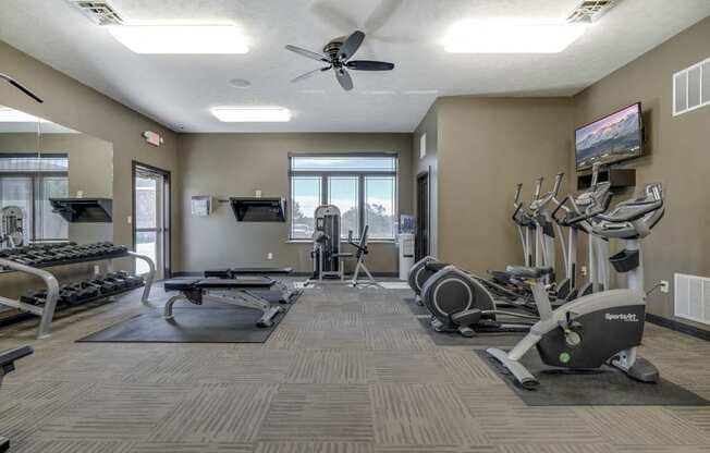 Fitness center with free weights and cardio equipment at North Pointe Villas