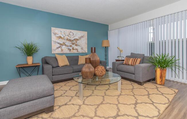 a living room filled with furniture and a large window