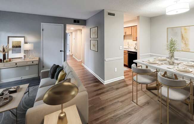 a living room and dining room with a table and chairs