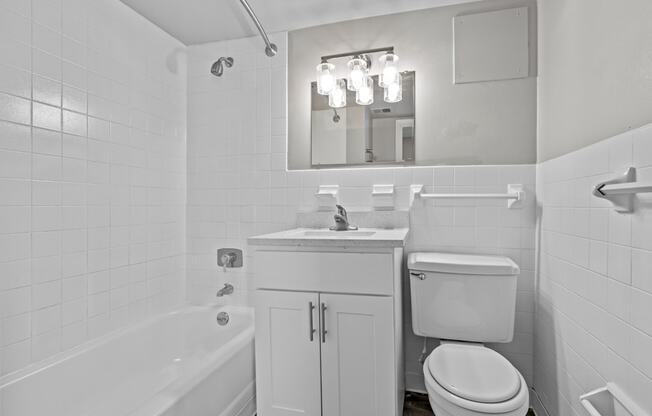 a bathroom with a sink toilet and a bath tub