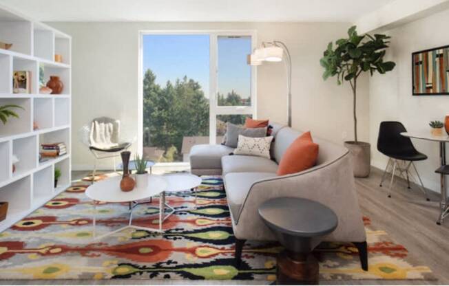 Living Room with white bookshelf, plank flooring, and large floor-to-ceiling windows at Arabella Apartment Homes, Shoreline, WA, 98155