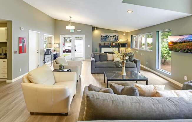 a living room with couches and chairs and a table