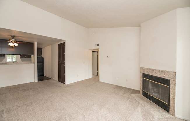A living room with a fireplace and a carpeted floor at Pepperwood Apartments, California, 95661