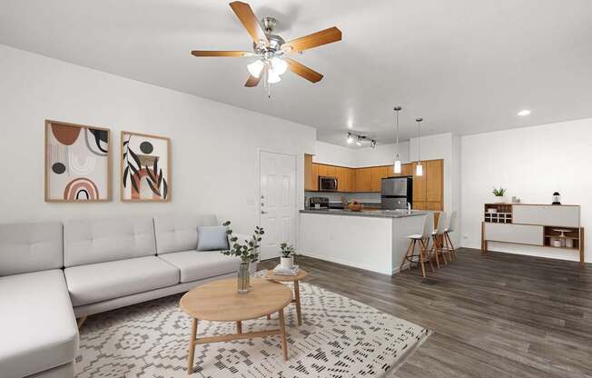 A living room with a white couch and a wooden coffee table.