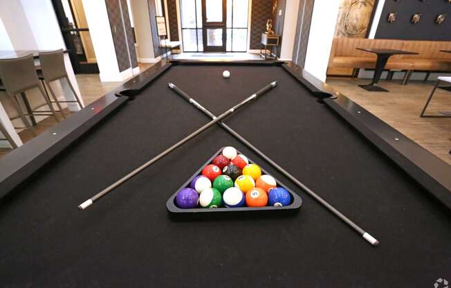 a pool table with a bunch of balls on it at Century Baxter Avenue, Kentucky