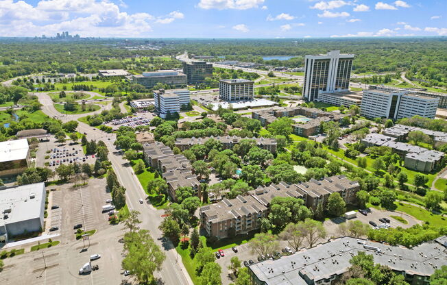 A bird's eye view of a city with buildings, roads, and cars.