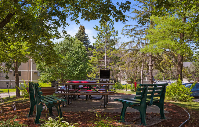 a picnic area with benches and tables in a park