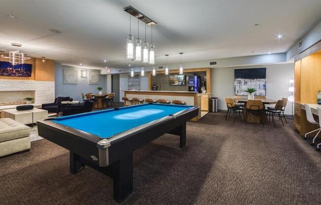 A room with a pool table and a TV.