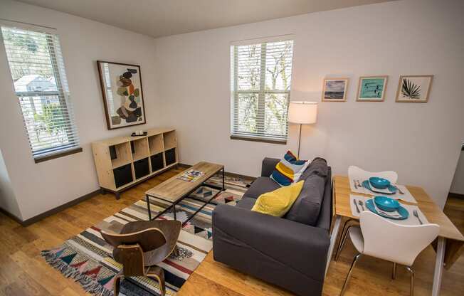 Apartments in Portland, OR - Living Room With Stylish Decor, Hardwood Flooring, and Access to Outdoor Patio