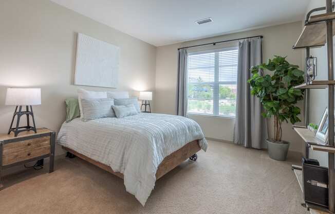 an empty bedroom with a bed and a window