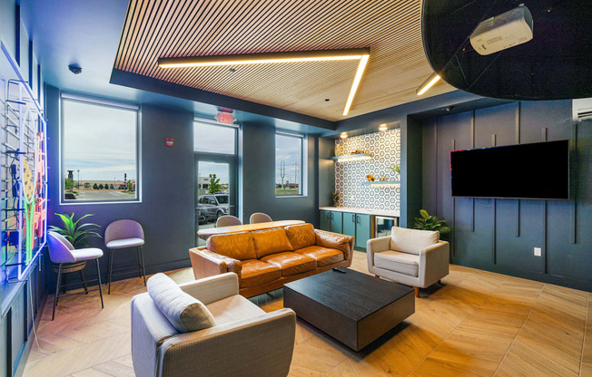 a lobby with couches and chairs and a tv at EagleRidge Plaza Residences, Fargo