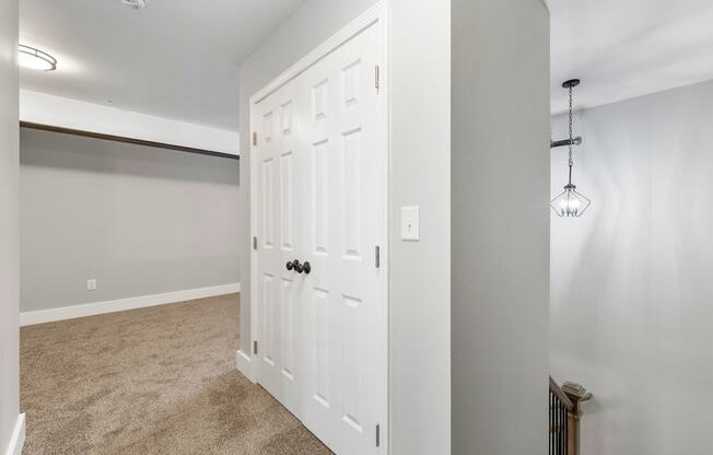 an empty bedroom with a closet and a white door at Crogman School Lofts, Georgia, 30315