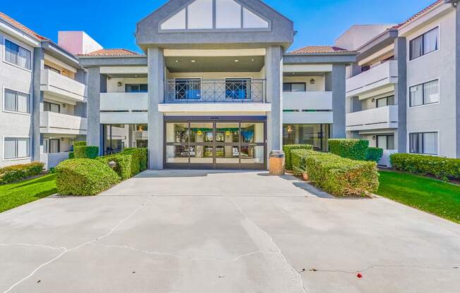 a large white building with a large driveway in front of it