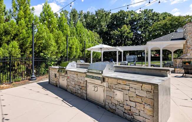 the preserve at ballantyne commons outdoor kitchen and patio with umbrellas at View at Lake Lynn, Raleigh, NC 27613