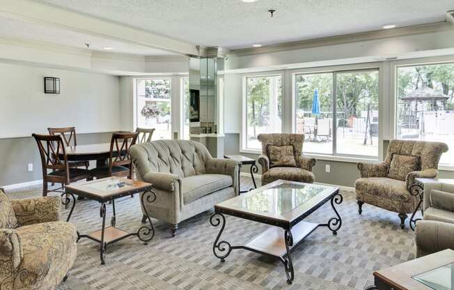 a living room with couches and chairs and a table