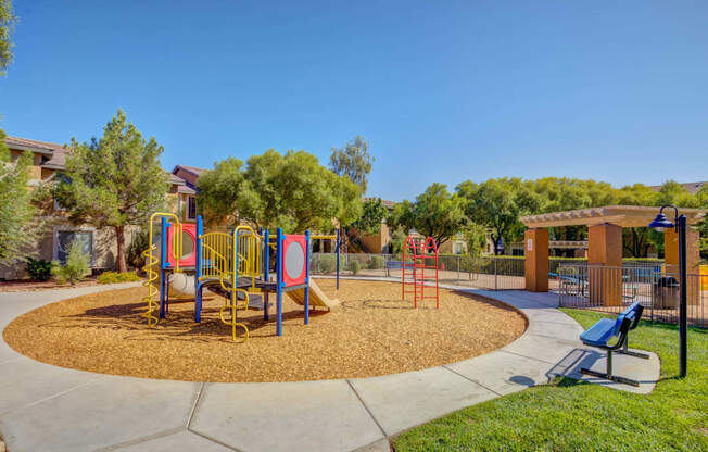 Spring Valley, NV, 89147 Apartments for Rent - Alicante - Playground with a Slide, Monkey Bars, and a Park Bench