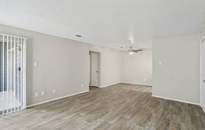A6 living room with vinyl wood flooring and a ceiling fan Windridge on the Parkway apartments in Dallas, TX