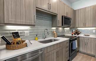 A modern kitchen with wooden cabinets and stainless steel appliances.
