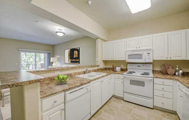 a kitchen with white cabinets and white appliances