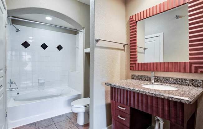 a bathroom with a bathtub and a sink At Metropolitan Apartments in Little Rock, AR