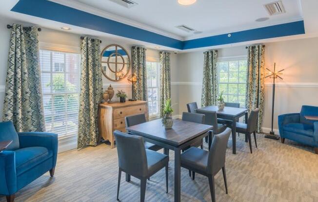 a room with a table chairs and a clock on the wall at Sterling Manor, Williamsburg