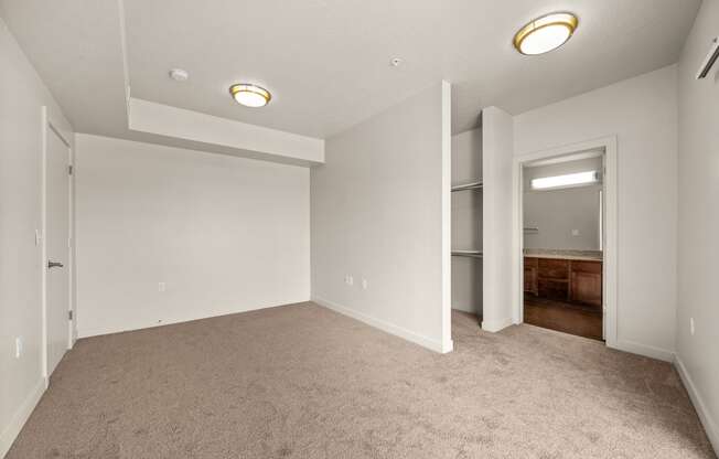 a bedroom with gray carpet and white walls