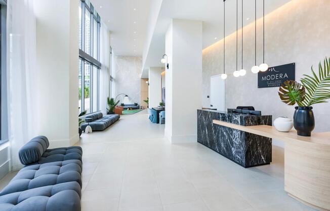 A warm welcome awaits at Modera Riverside’s sophisticated lobby with modern design and natural light.