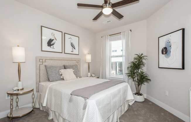 a bedroom with a bed and a ceiling fan