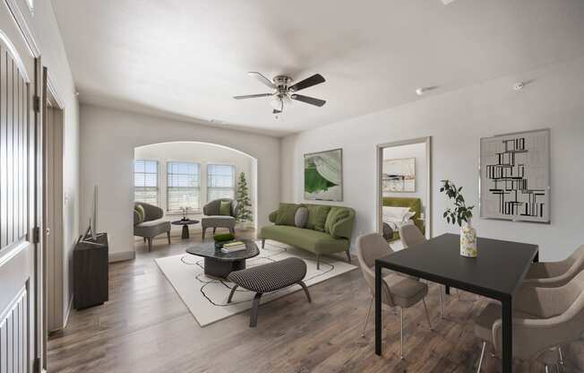 a living room with a ceiling fan and hardwood floors