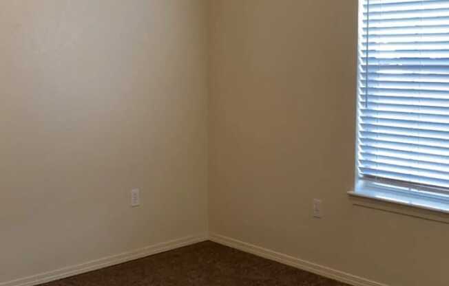 an empty room with a window and carpet at EDGEWOOD AT GABLES Apartments, TULSA