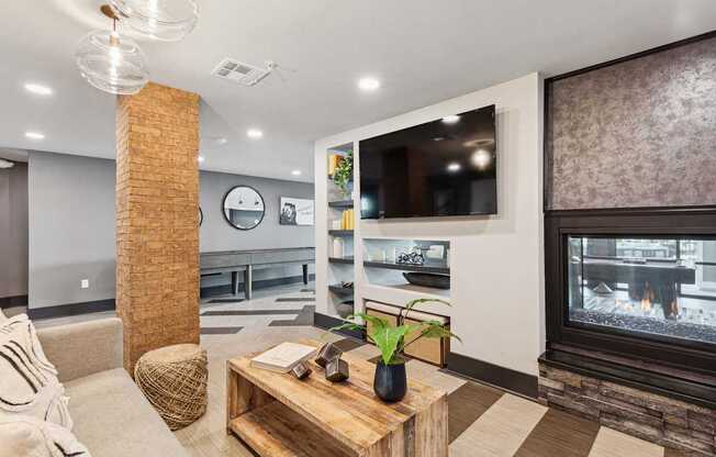 A modern living room with a fireplace and a flat screen TV.