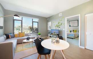 A modern living room with a large window and a view of the city.