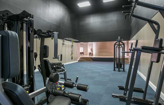 a gym with weights and other gym equipment in it