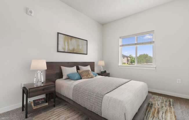 a bedroom with a large bed and two night stands with lamps