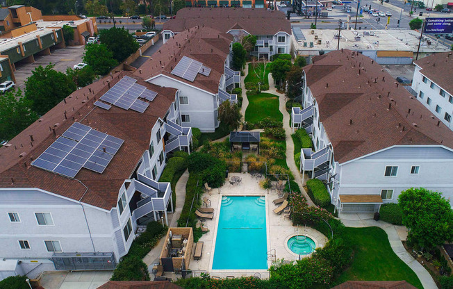 Aerial view of the courtyard, pool, jacuzzi, and solar panels.