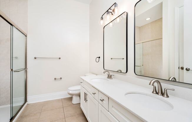 a bathroom with two sinks and a toilet