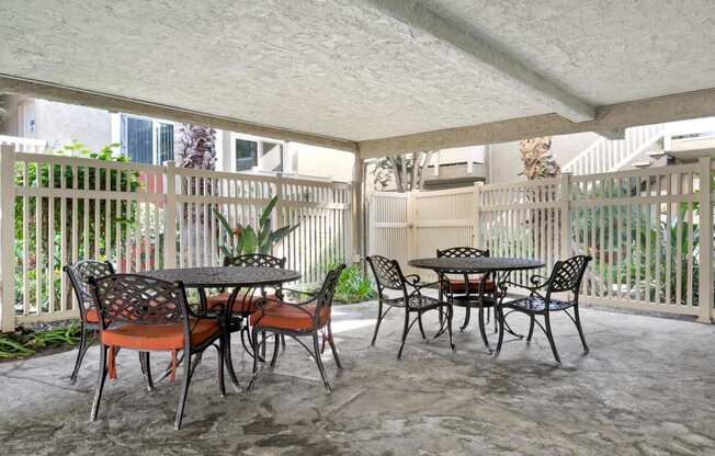 Marina Del Rey, CA Apartments - Casa De Marina - Patio Area With Two Outdoor Patio Sets with Chairs Within a Gated Area