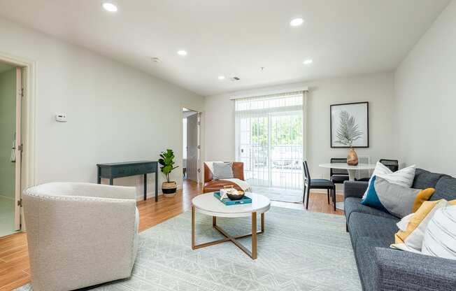 The sto one bedroom living room  with overhead lighting fixtures and balcony