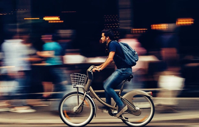 a man riding a bike down a city street