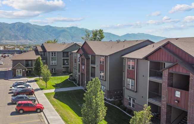 an aerial view of an apartment complex with mountains in the background