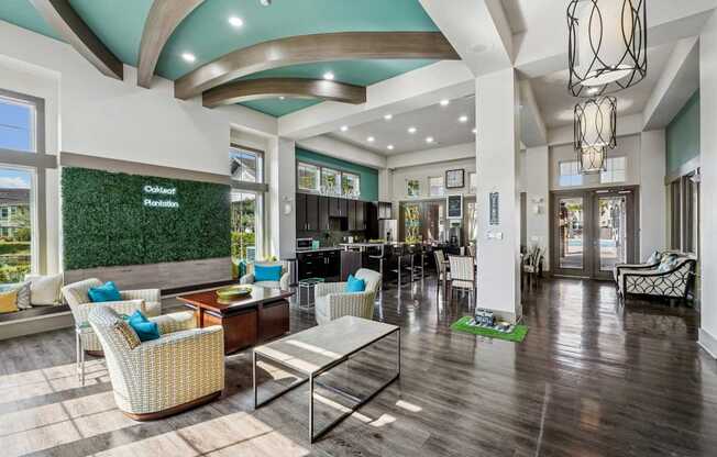 A large, well-lit lobby with a green wall and a variety of seating options.