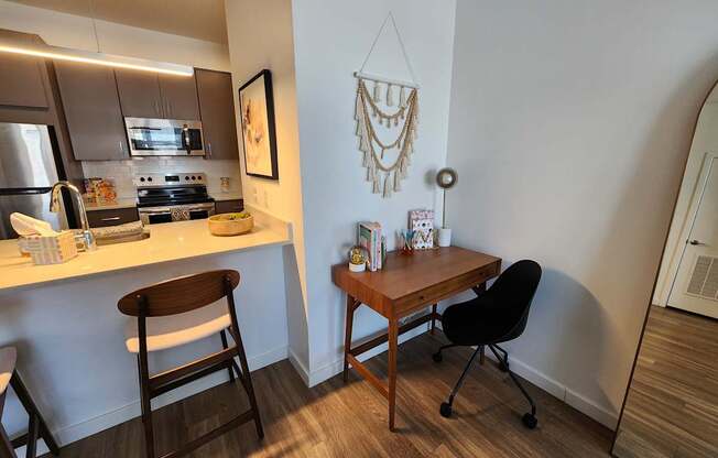 A kitchen with a table and chairs.