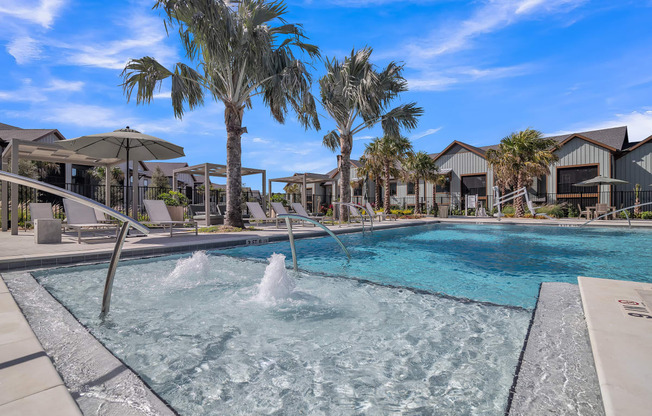 a swimming pool with palm trees and houses in the background at Canter, Ocala, Florida