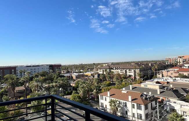 the view of the city from the balcony of a condo