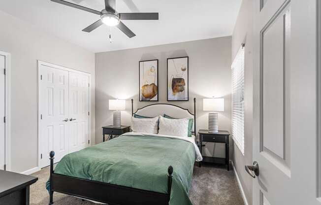 a bedroom with a bed and a ceiling fan