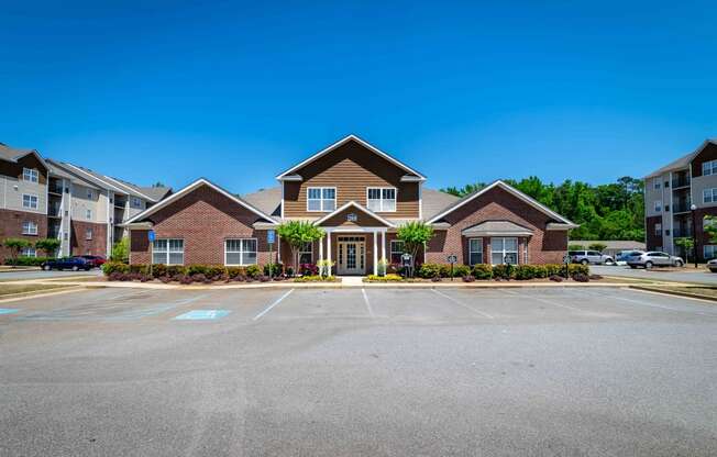 an empty parking lot in front of a brick house