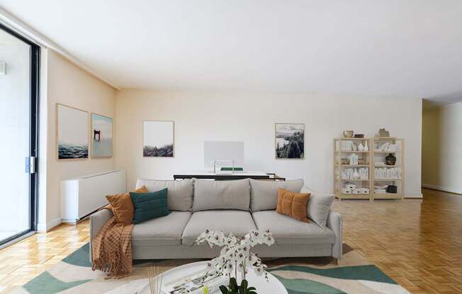 A living room with a grey couch and a white coffee table.
