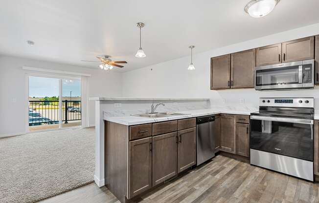 a kitchen with wooden cabinets and stainless steel appliances